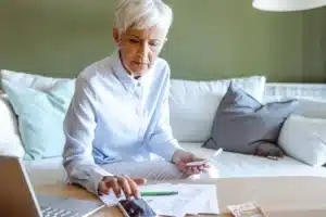mature woman calculating her retirement income