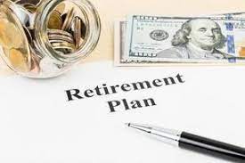 Money sitting beside a retirement plan document